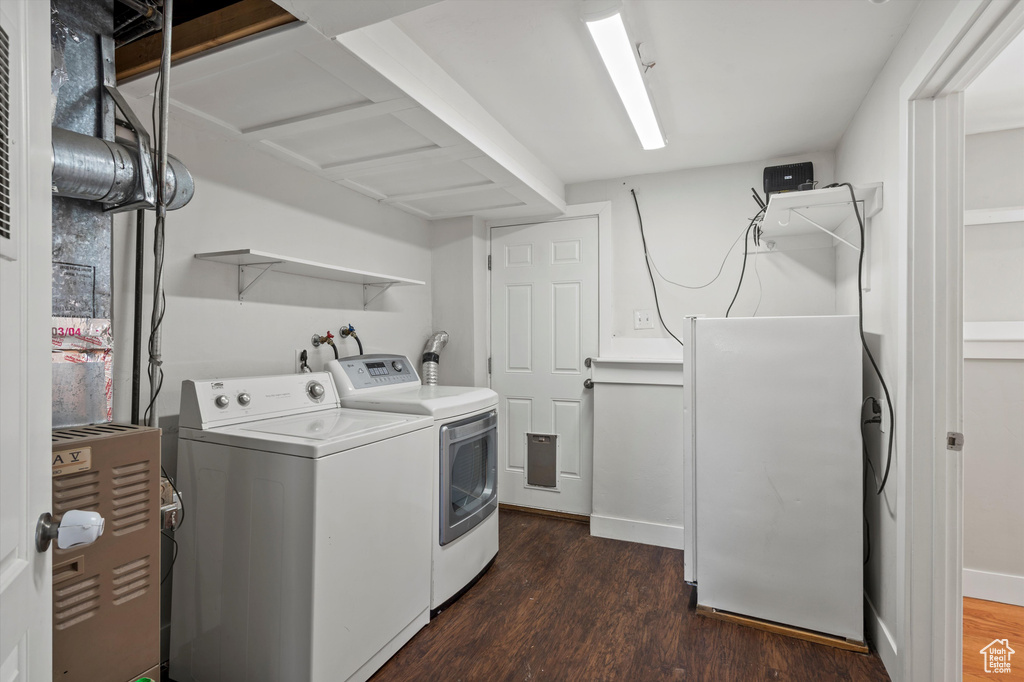 Laundry area with washing machine and clothes dryer and dark wood-style floors