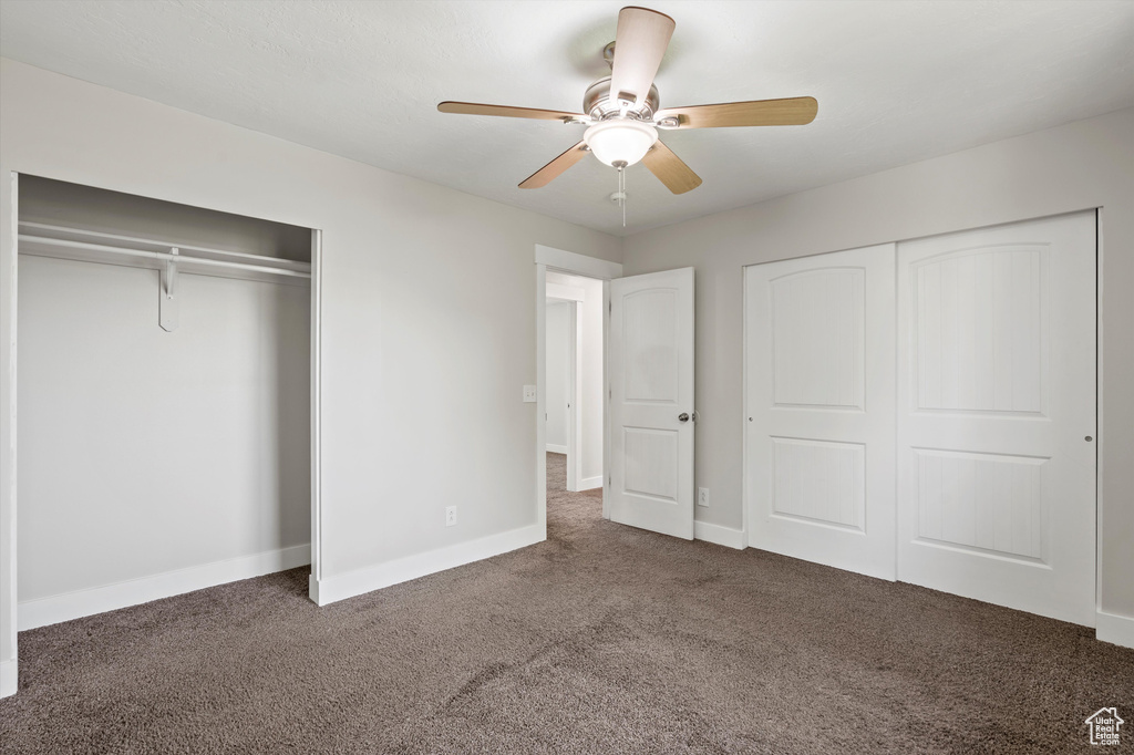 Unfurnished bedroom featuring carpet, a closet, and ceiling fan