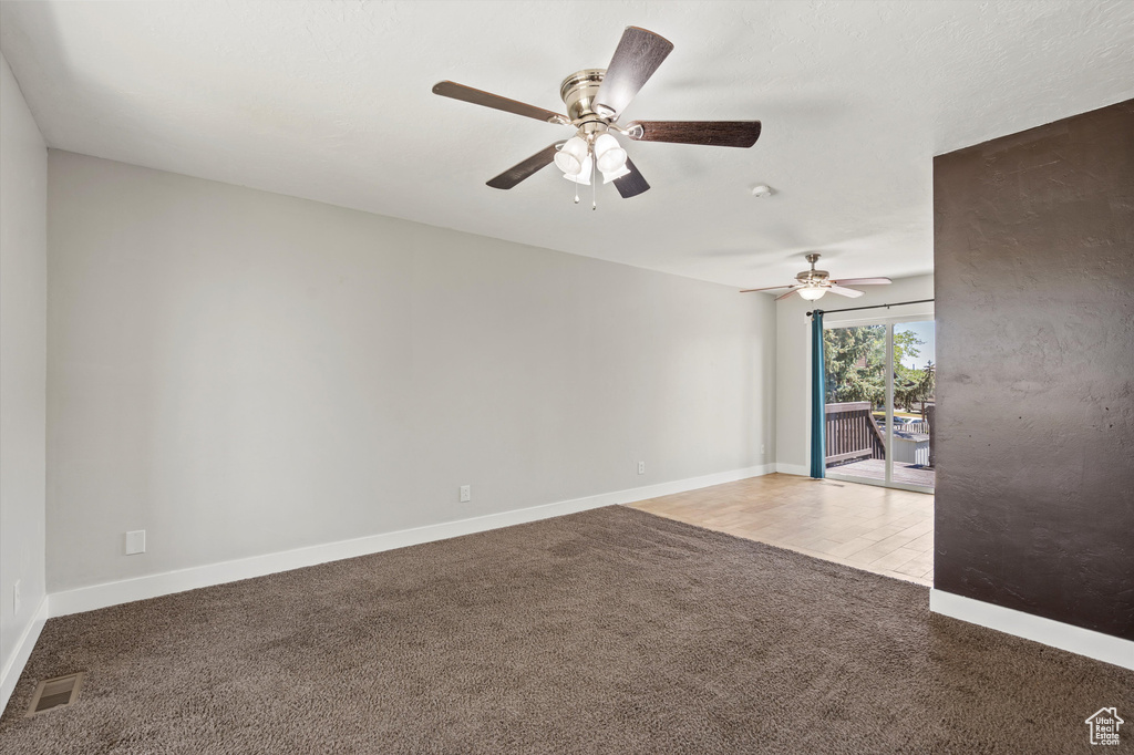 Unfurnished room featuring carpet flooring and ceiling fan