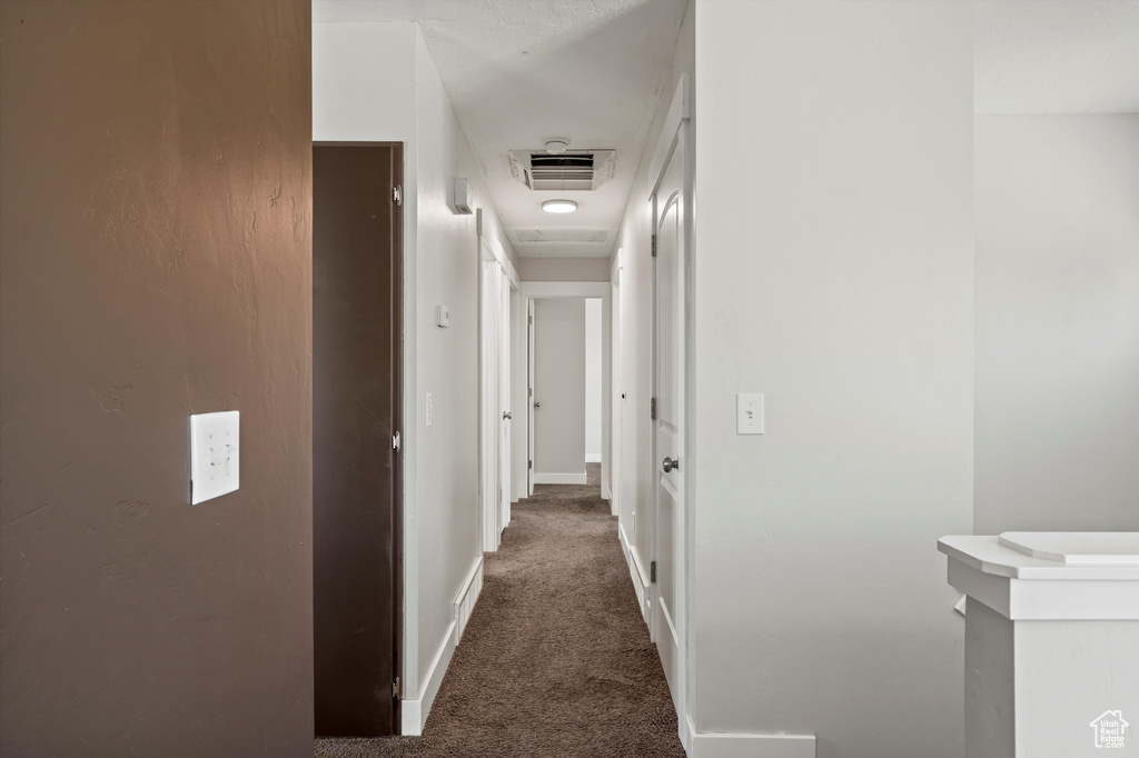 Corridor with carpet and baseboards