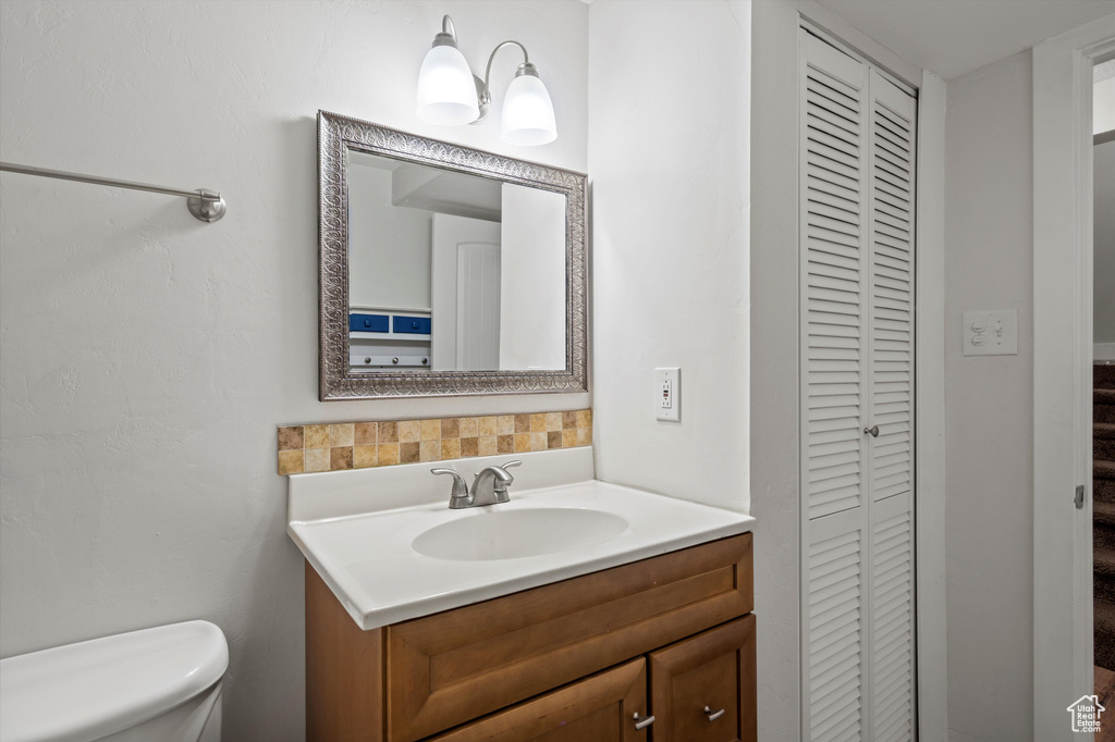 Bathroom with a closet and vanity