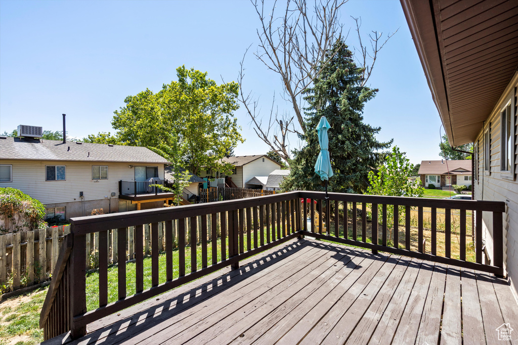 Wooden terrace with a residential view and a fenced backyard