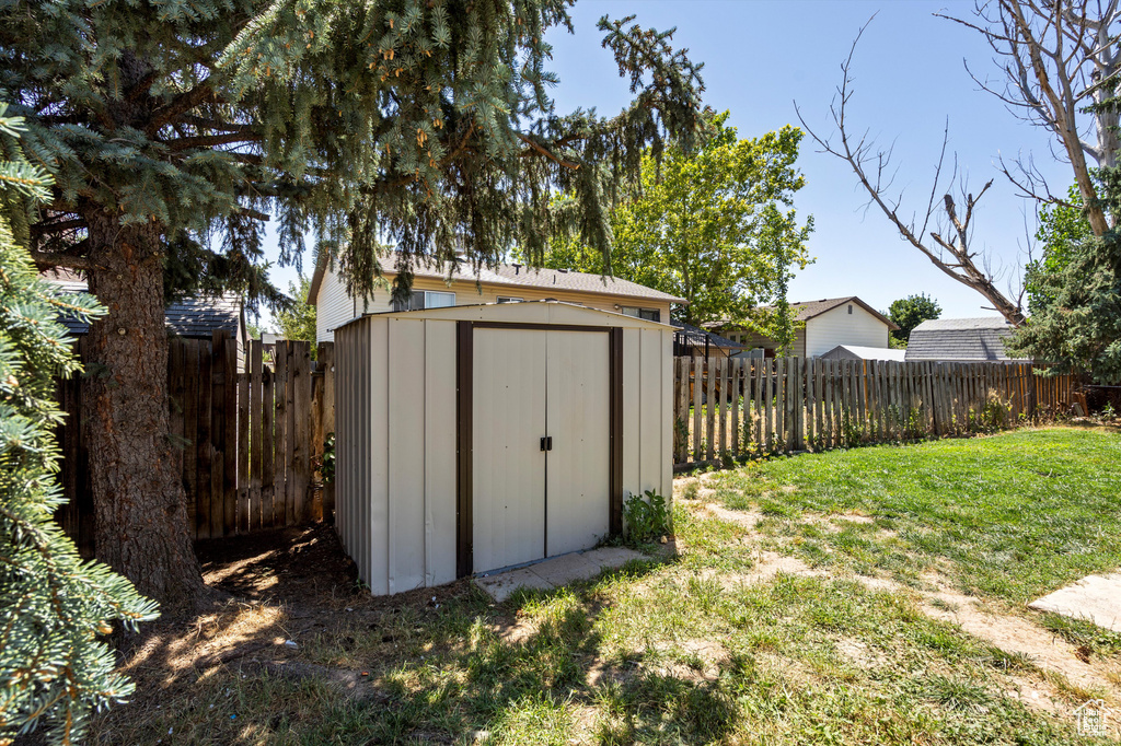 View of shed featuring a fenced backyard