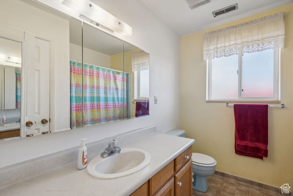 Bathroom featuring vanity and curtained shower