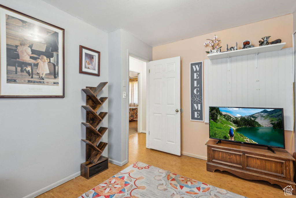 Sitting room with wood finished floors and baseboards