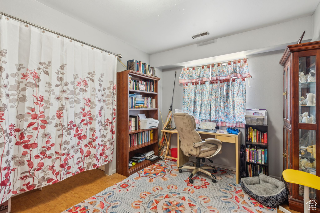 Home office with wood finished floors
