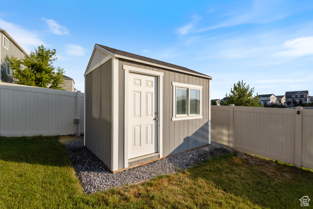 View of shed with a fenced backyard
