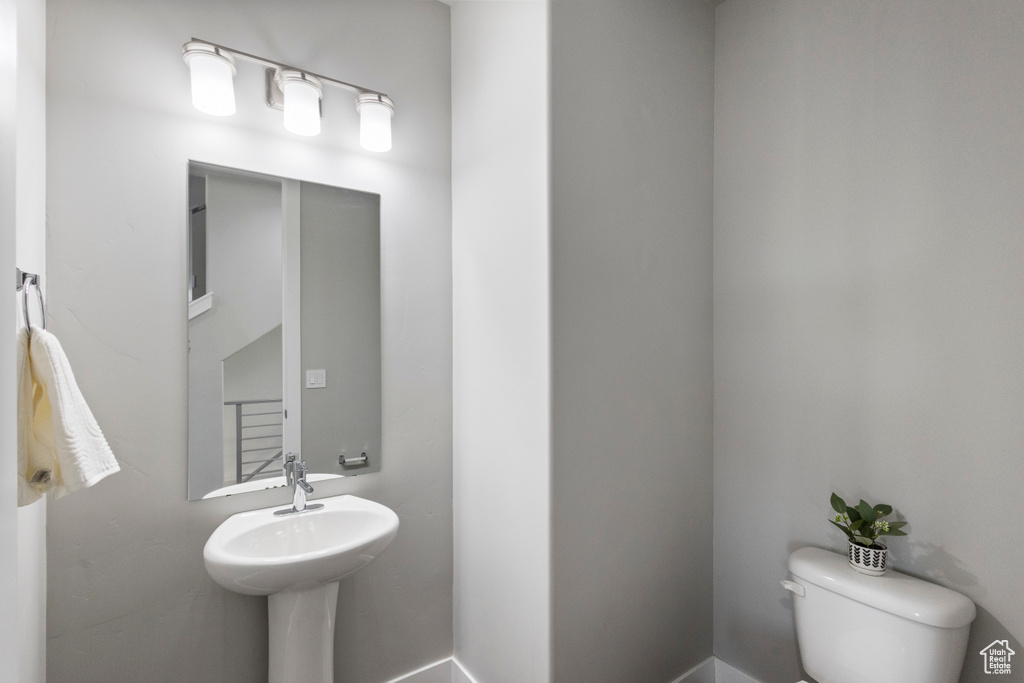 Bathroom featuring toilet and baseboards