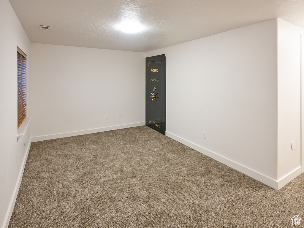 Spare room featuring carpet flooring