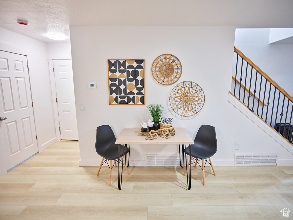 Dining room with wood finished floors and stairs
