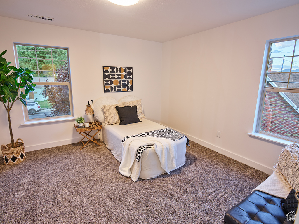 Bedroom featuring carpet floors and baseboards
