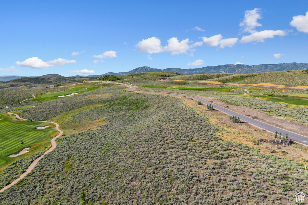 Aerial view of a mountainous background and a golf club