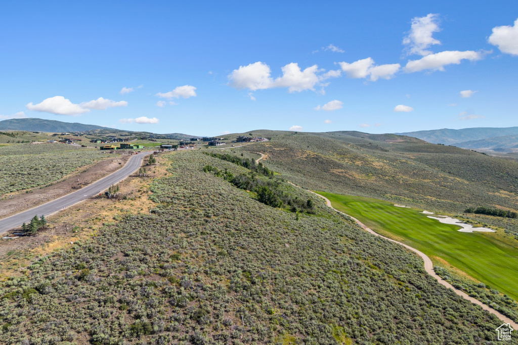 Drone / aerial view of mountains and a golf club