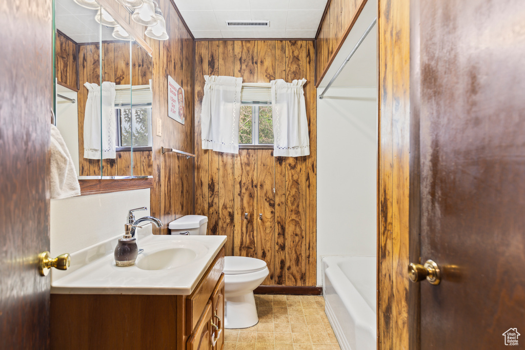 Full bathroom with vanity and wooden walls