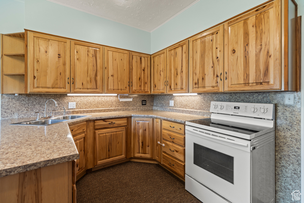 Kitchen featuring electric stove, ornamental molding, tasteful backsplash, light countertops, and brown cabinets