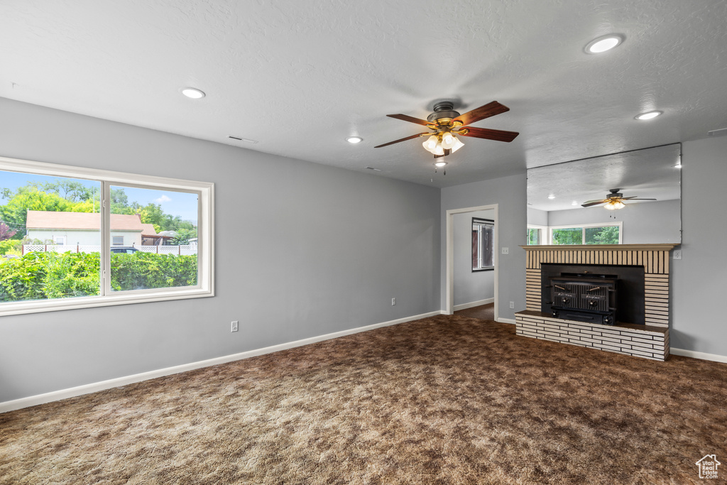 Unfurnished living room featuring ceiling fan, recessed lighting, and carpet floors