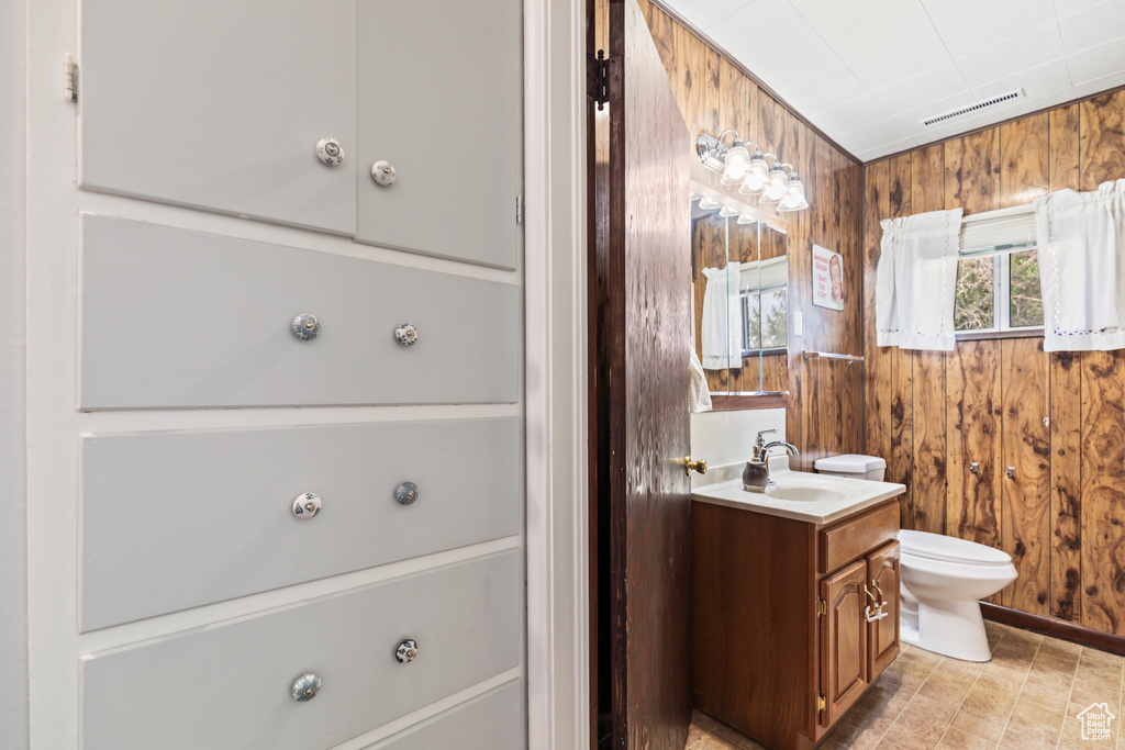 Bathroom featuring vanity and wooden walls