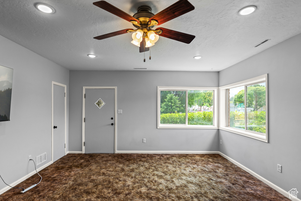 Spare room featuring carpet flooring, a textured ceiling, a ceiling fan, and recessed lighting