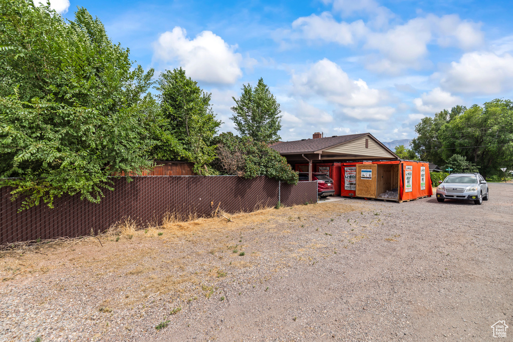 View of front of house featuring gravel driveway