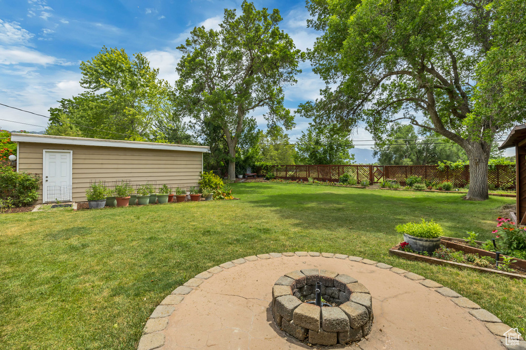 View of yard with an outdoor fire pit