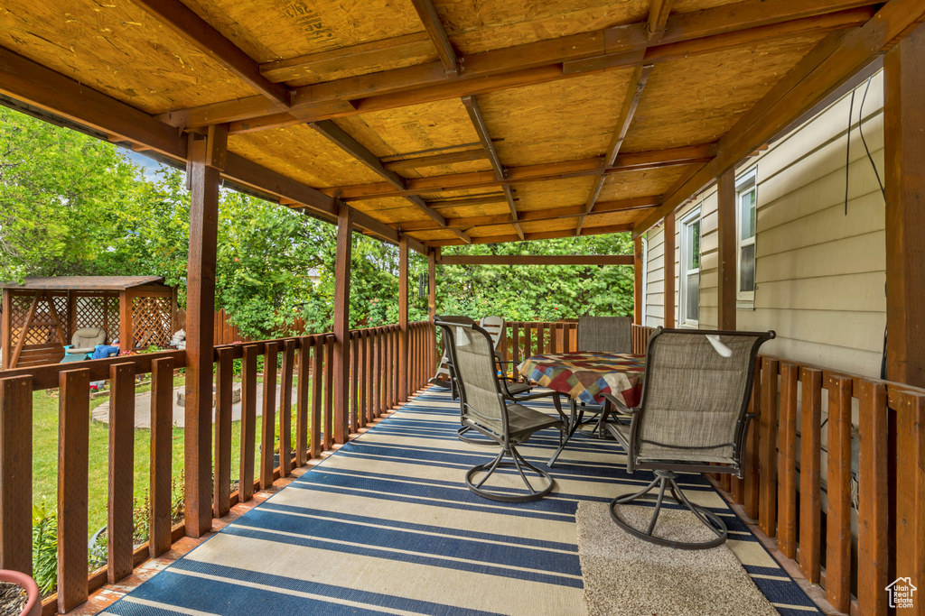 Wooden terrace featuring outdoor dining area