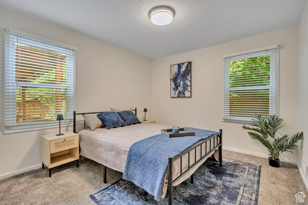 Carpeted bedroom featuring baseboards