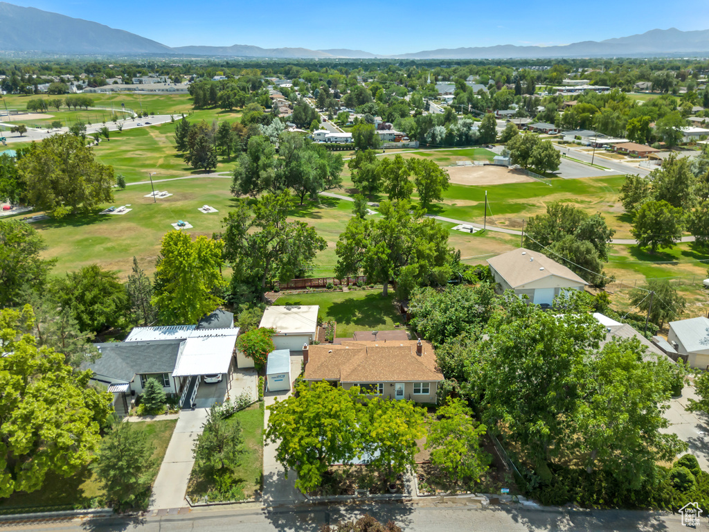 Aerial perspective of suburban area with a mountainous background and a golf course