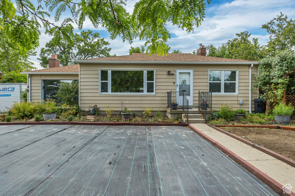 Bungalow-style house featuring a chimney