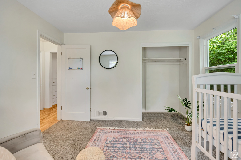 Bedroom with carpet and a closet