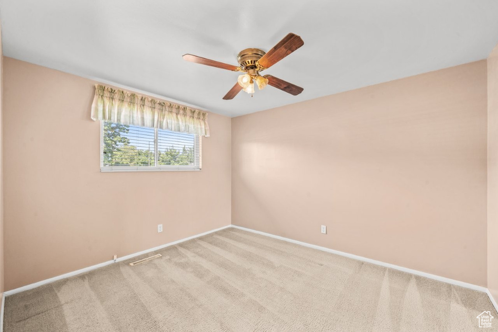 Unfurnished room with ceiling fan and carpet floors