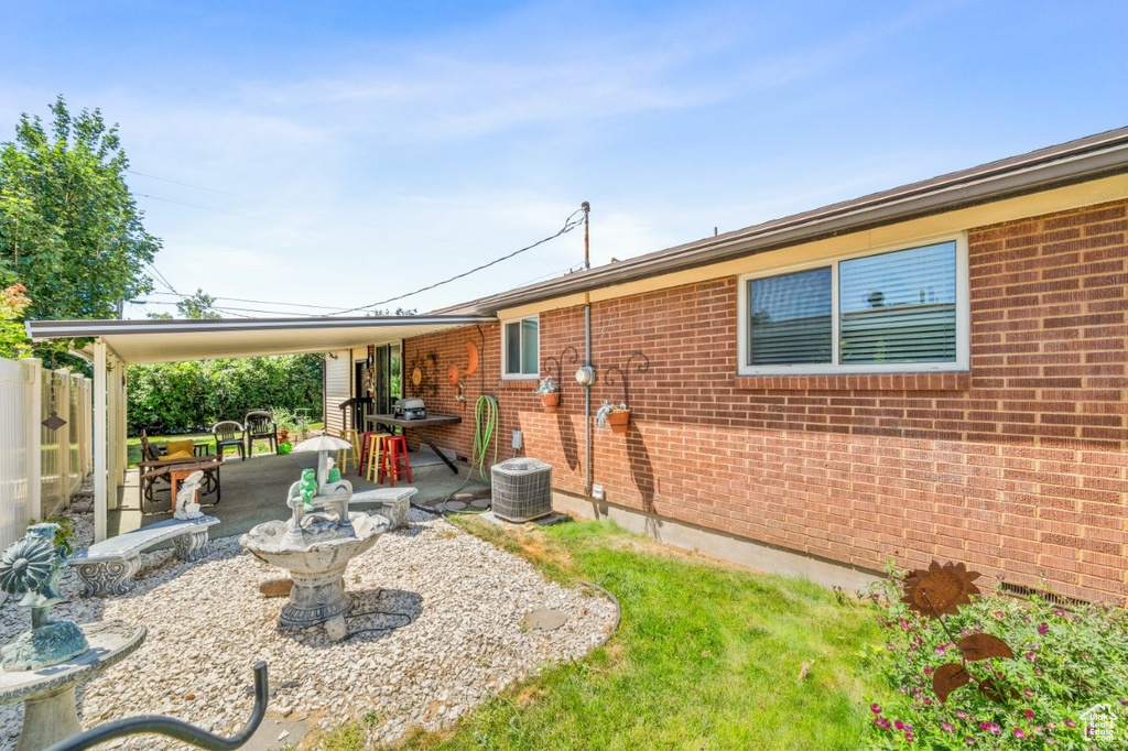 Rear view of property featuring a patio area and brick siding