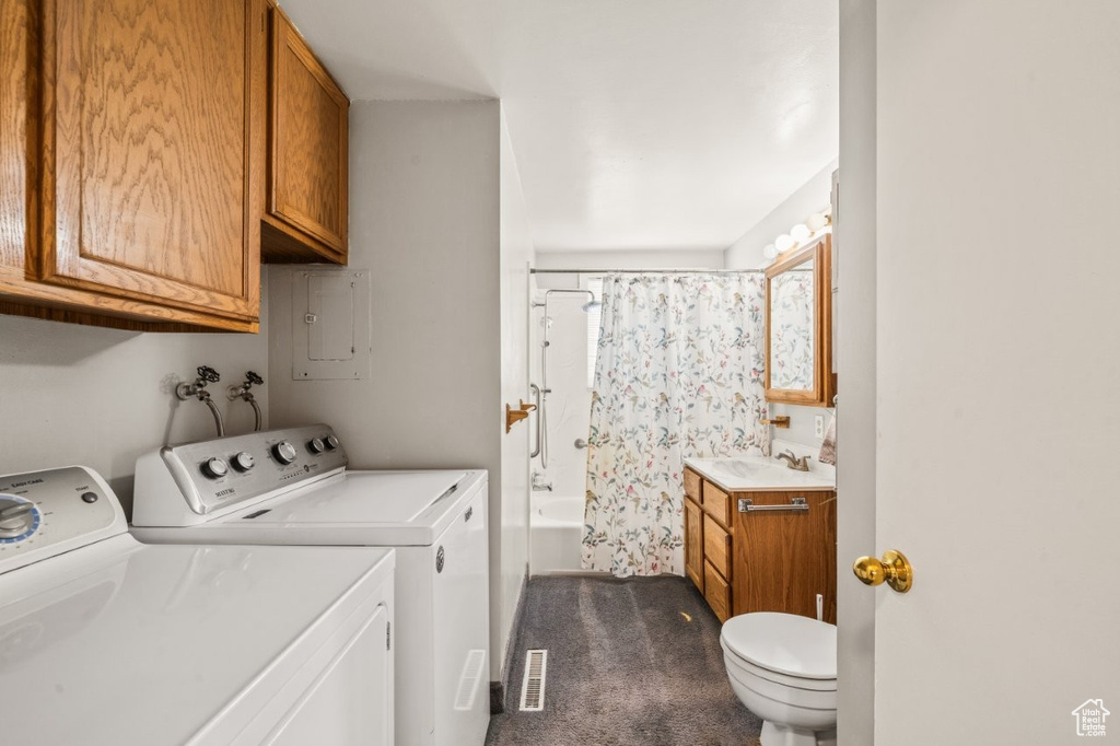 Laundry area featuring separate washer and dryer, electric panel, and dark carpet