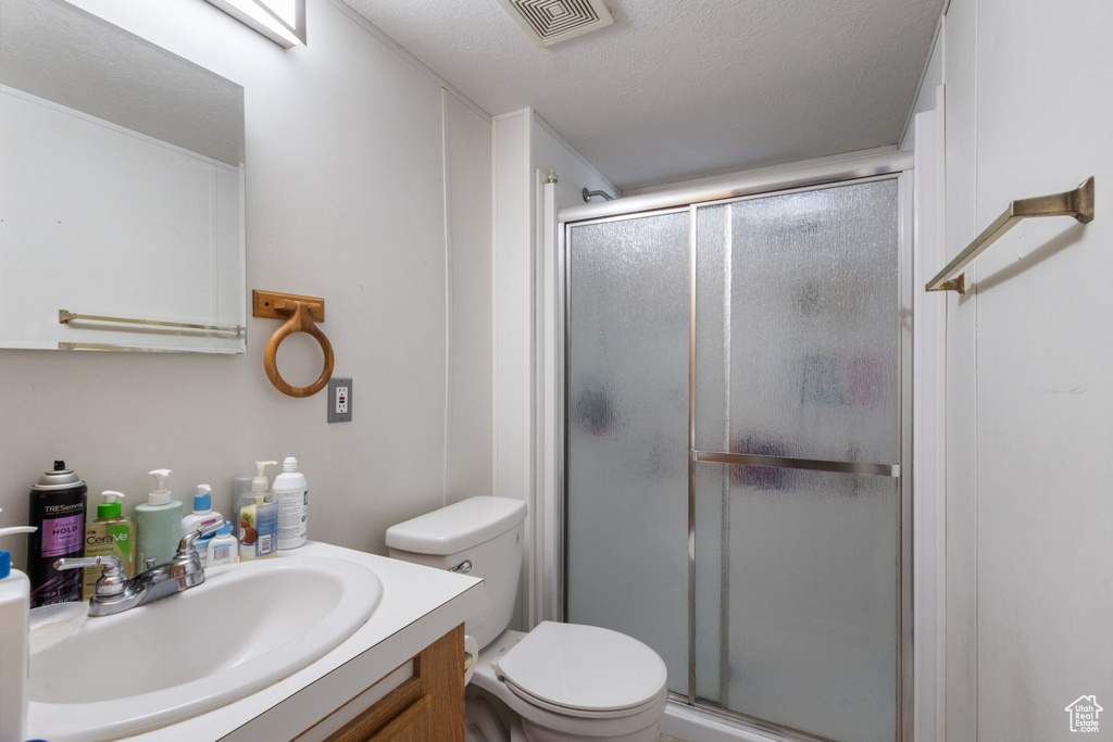 Bathroom featuring vanity and a stall shower