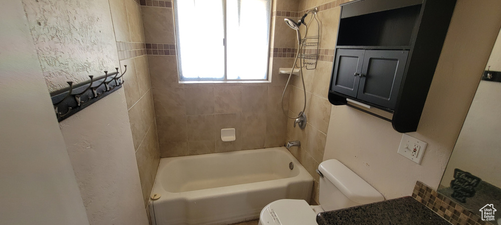 Full bathroom with toilet and shower / tub combination