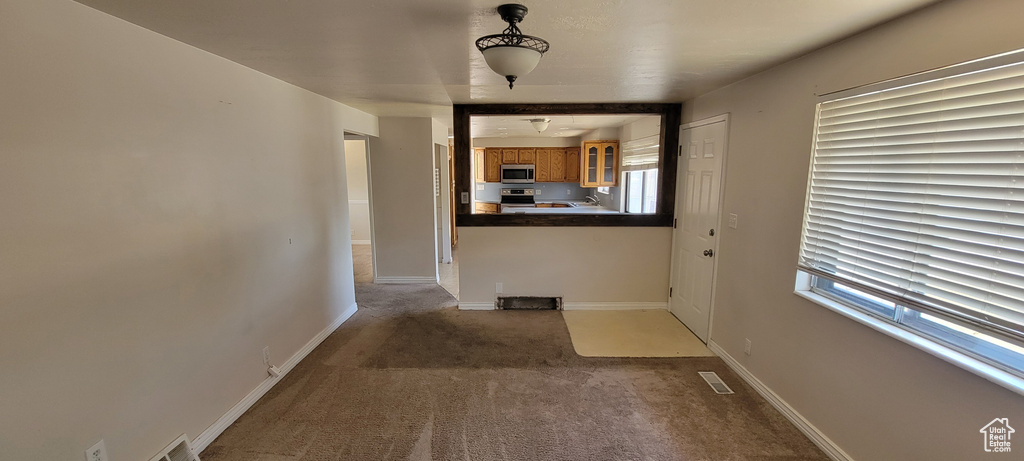 Corridor with carpet and baseboards