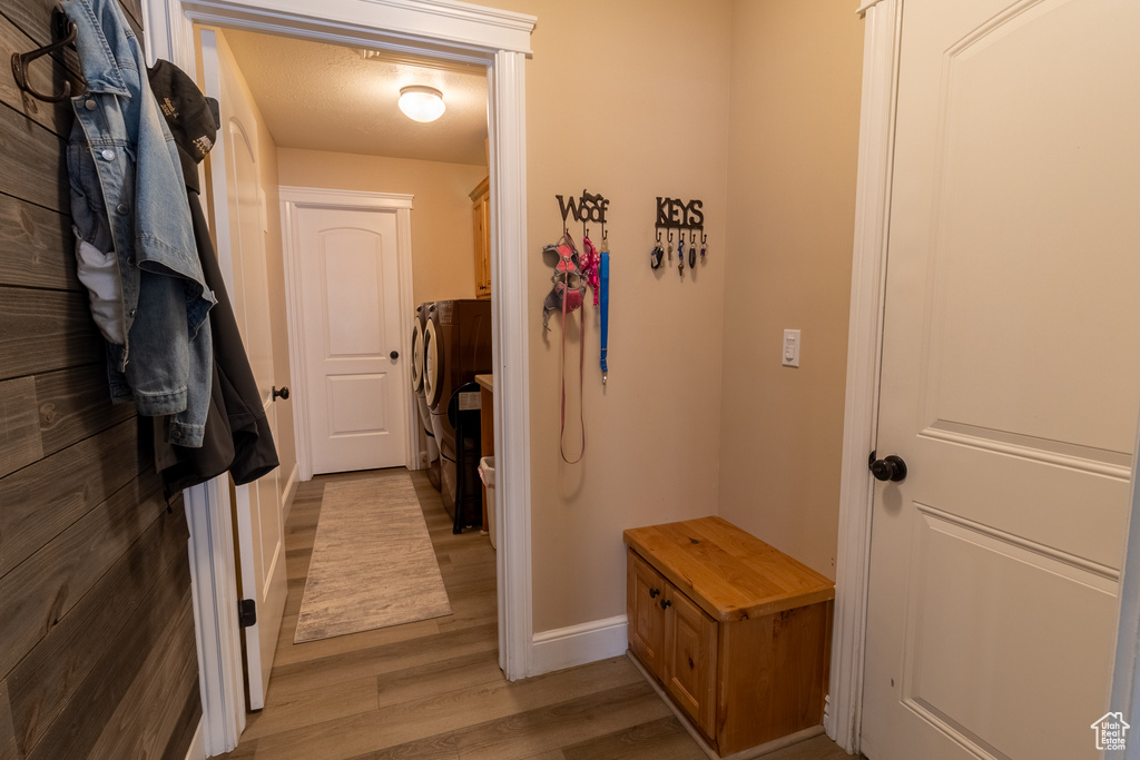Hallway featuring light wood-style flooring and baseboards