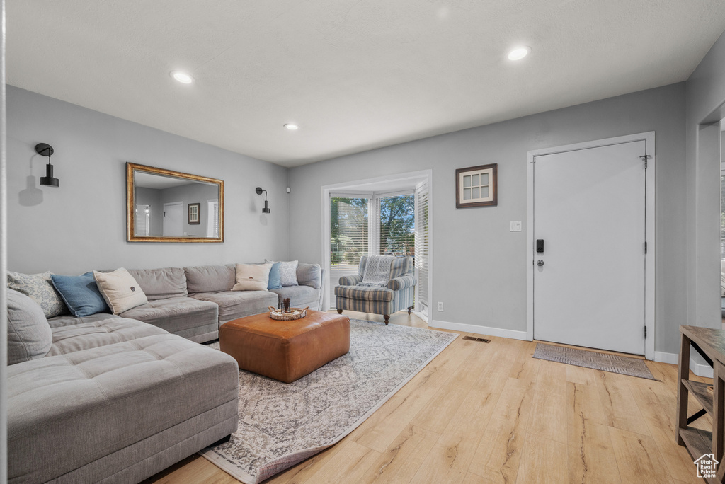 Living room featuring recessed lighting and light wood-style floors