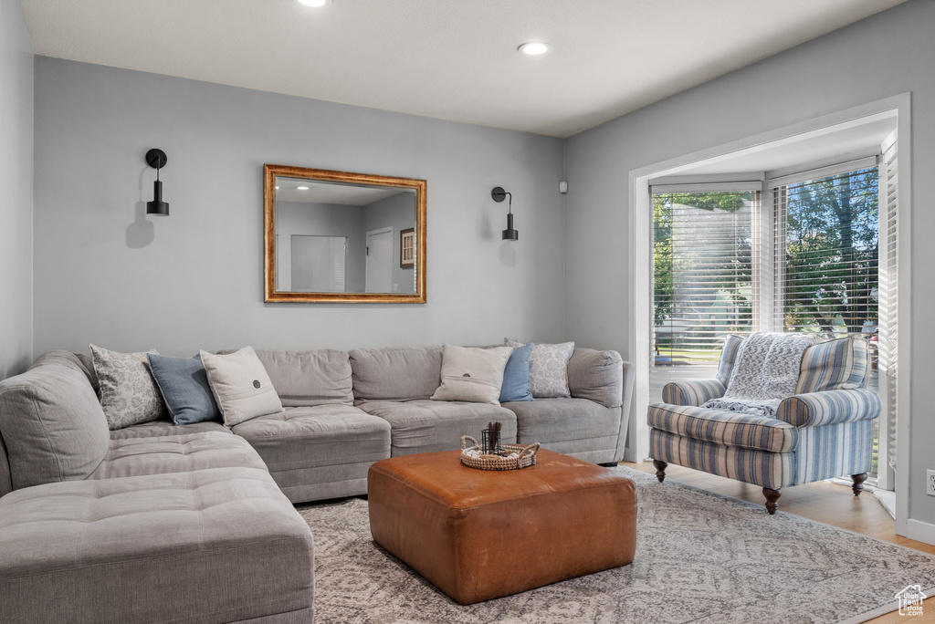 Living area with recessed lighting and light wood-style floors
