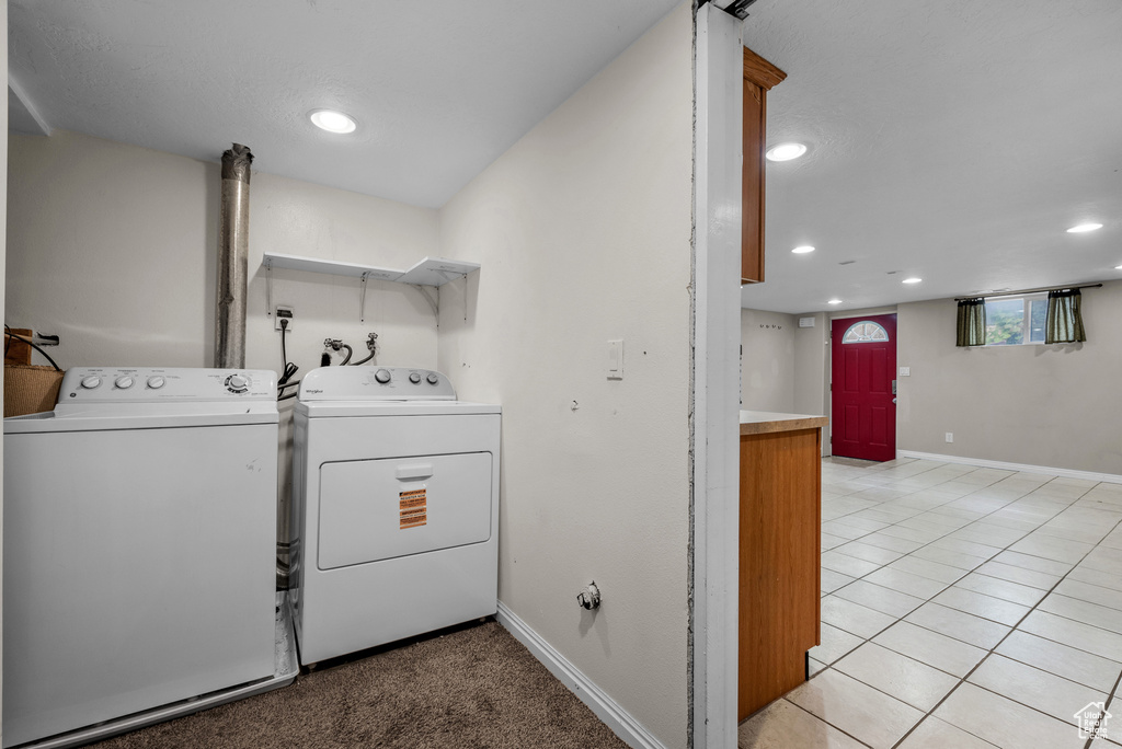 Laundry room featuring separate washer and dryer, recessed lighting, and light tile patterned flooring