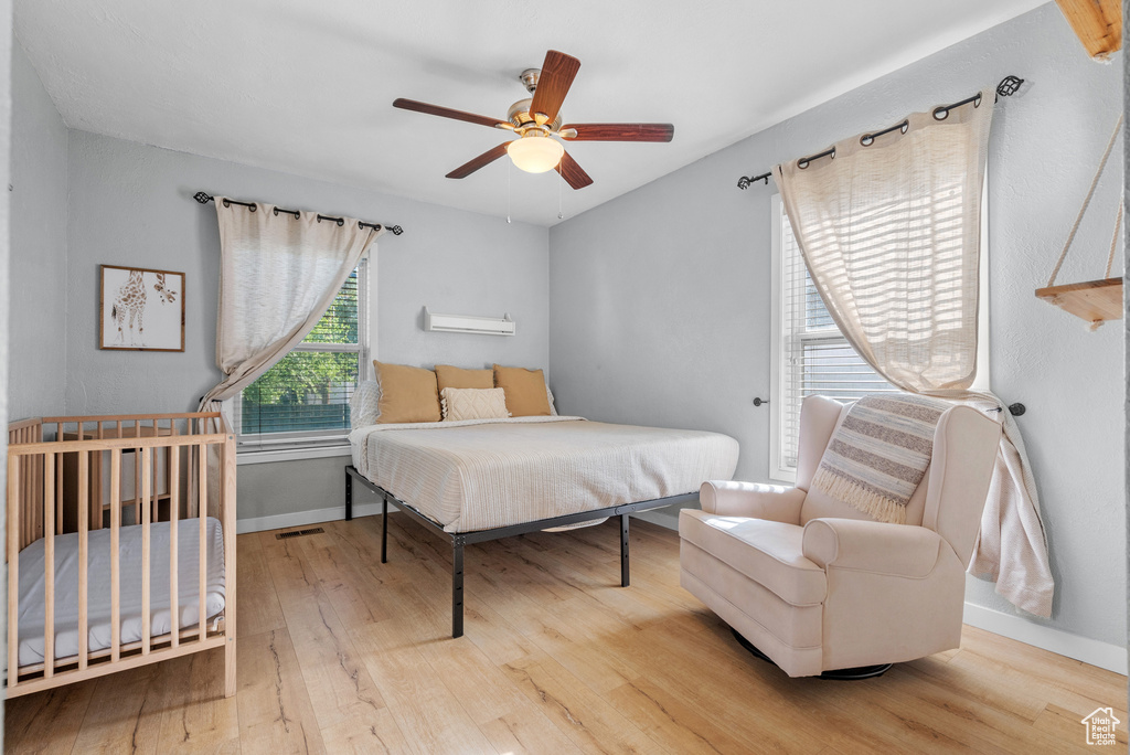 Bedroom with wood finished floors and ceiling fan