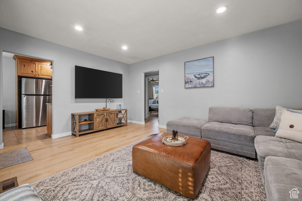 Living room featuring light wood-style flooring and recessed lighting
