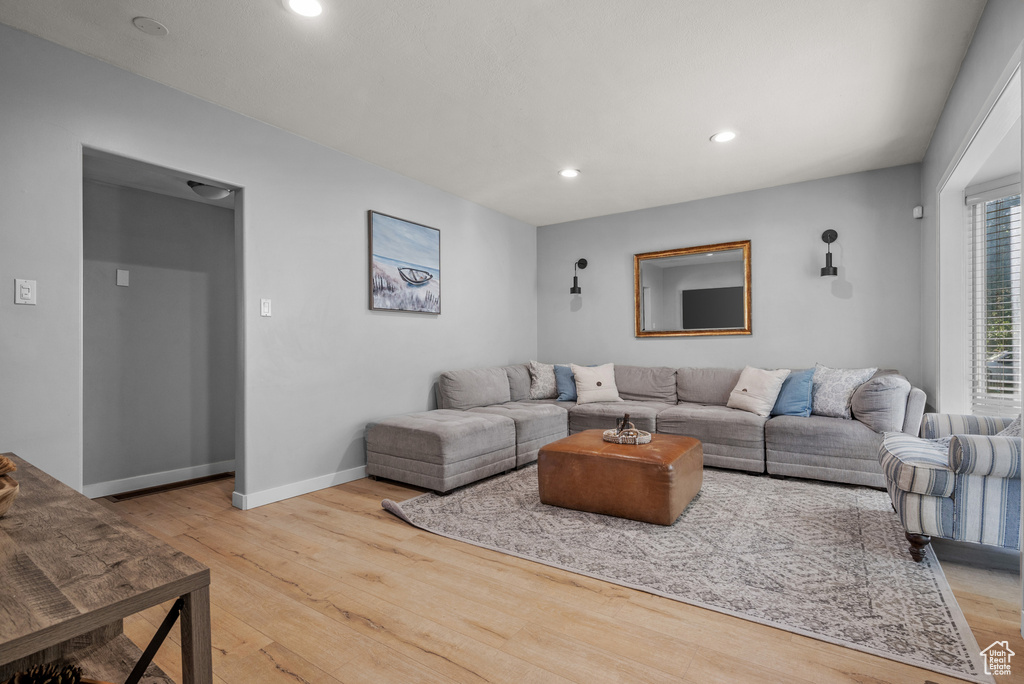 Living area with wood finished floors and recessed lighting
