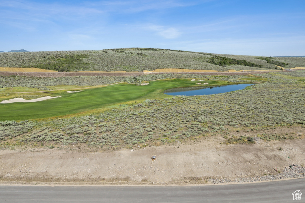 Surrounding community featuring a water and mountain view and golf course view