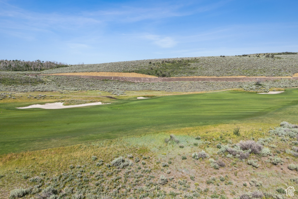View of home's community featuring golf course view and a yard