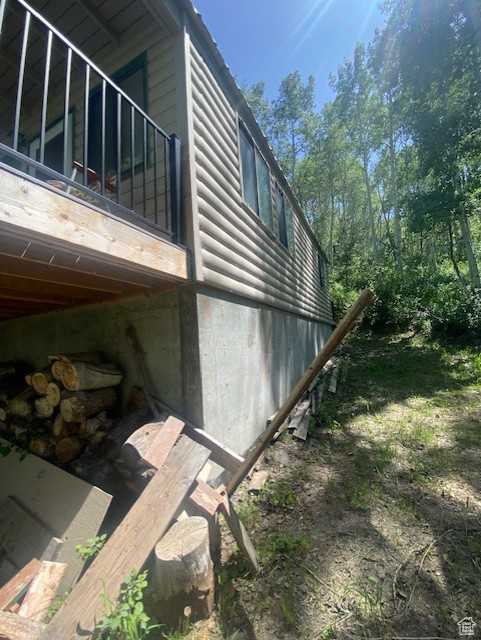 View of side of home featuring faux log siding