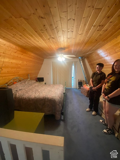 Carpeted bedroom featuring wooden ceiling