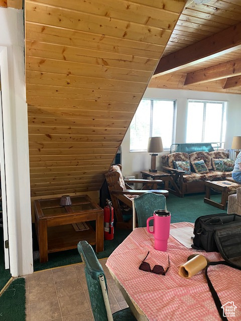 Dining room featuring a wooden ceiling with exposed beams