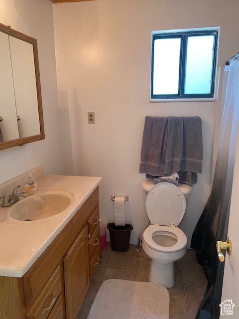 Full bathroom featuring vanity, tile patterned flooring, and a shower with curtain