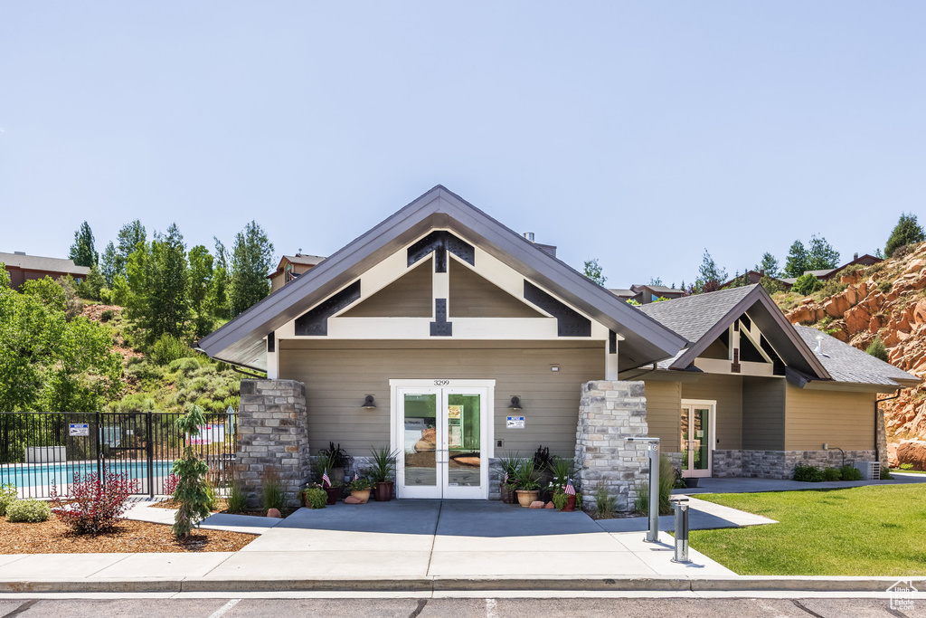 View of front of house featuring french doors and stone siding