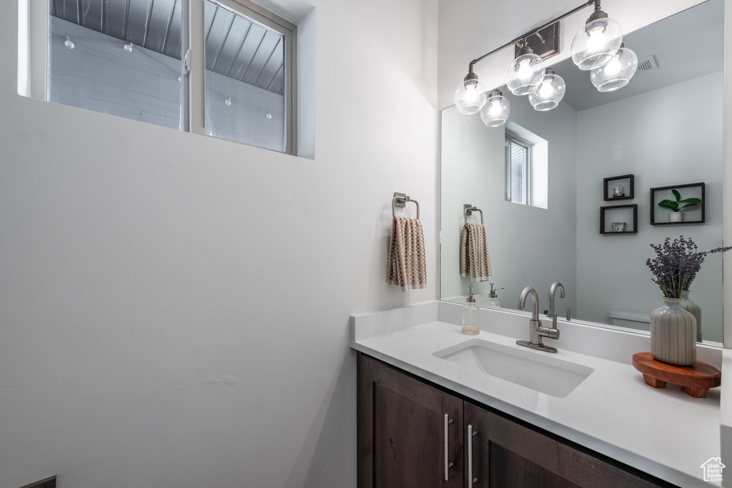 Bathroom featuring vanity and toilet